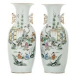 A pair of Chinese polychrome decorated vases with goats, boys playing in a garden and calligraphic