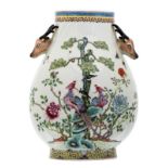 A Chinese famille rose decorated Hu vase with birds and flower branches, the handles deer head