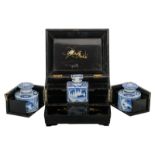 A black lacquered wood mother-of-pearl mounted cellaret with three Chinese blue and white tea