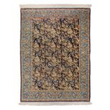 An Oriental rug, wool and silk on cotton, Isfahan, decorated with floral motifs, birds and wolves,