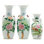 A pair of Chinese polychrome decorated vases with flower branches and calligraphic texts; added a