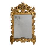 A mirror in a carved and gilt wooden Neoclassical 18thC frame, H 120,5 - W 73 cm