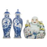 Two Chinese blue and white floral decorated baluster shaped vases and covers, the roundels with a