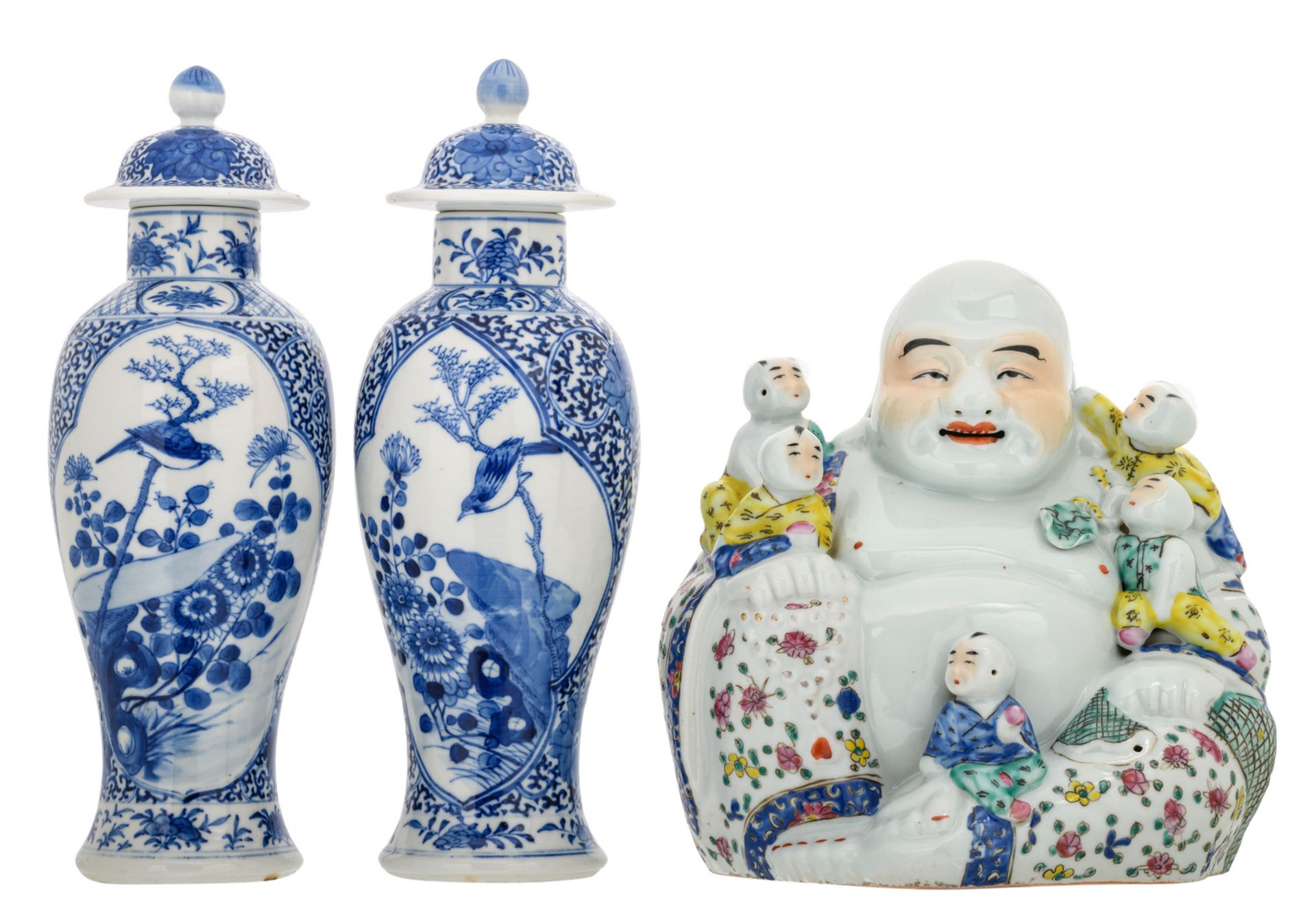 Two Chinese blue and white floral decorated baluster shaped vases and covers, the roundels with a