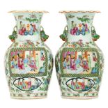 A pair of Chinese Canton famille rose floral decorated vases, the roundels with various court and