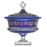A decorative blue overlay Val-Saint-Lambert crystal cut bowl and cover on foot, relief decorated