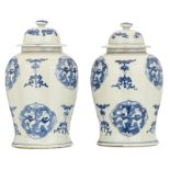 A pair of Chinese blue and white decorated vases and covers with auspicious symbols, the roundels