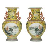 A pair of Chinese yellow ground polychrome and floral decorated vases, the roundels with mountainous