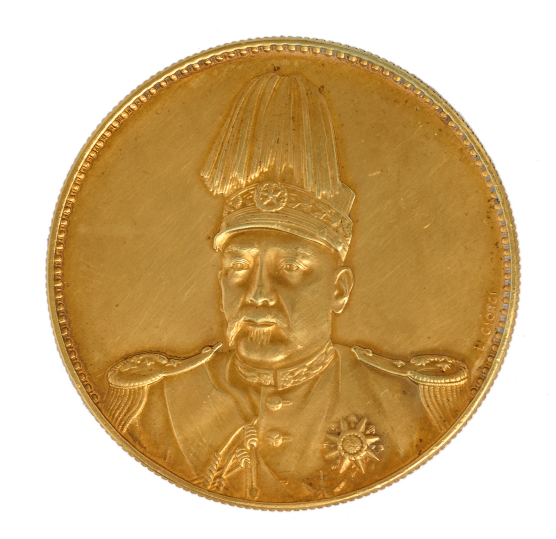 A Chinese commemorative 'golden' one dollar coin, depicting YuanShiKai, signed Giorgi