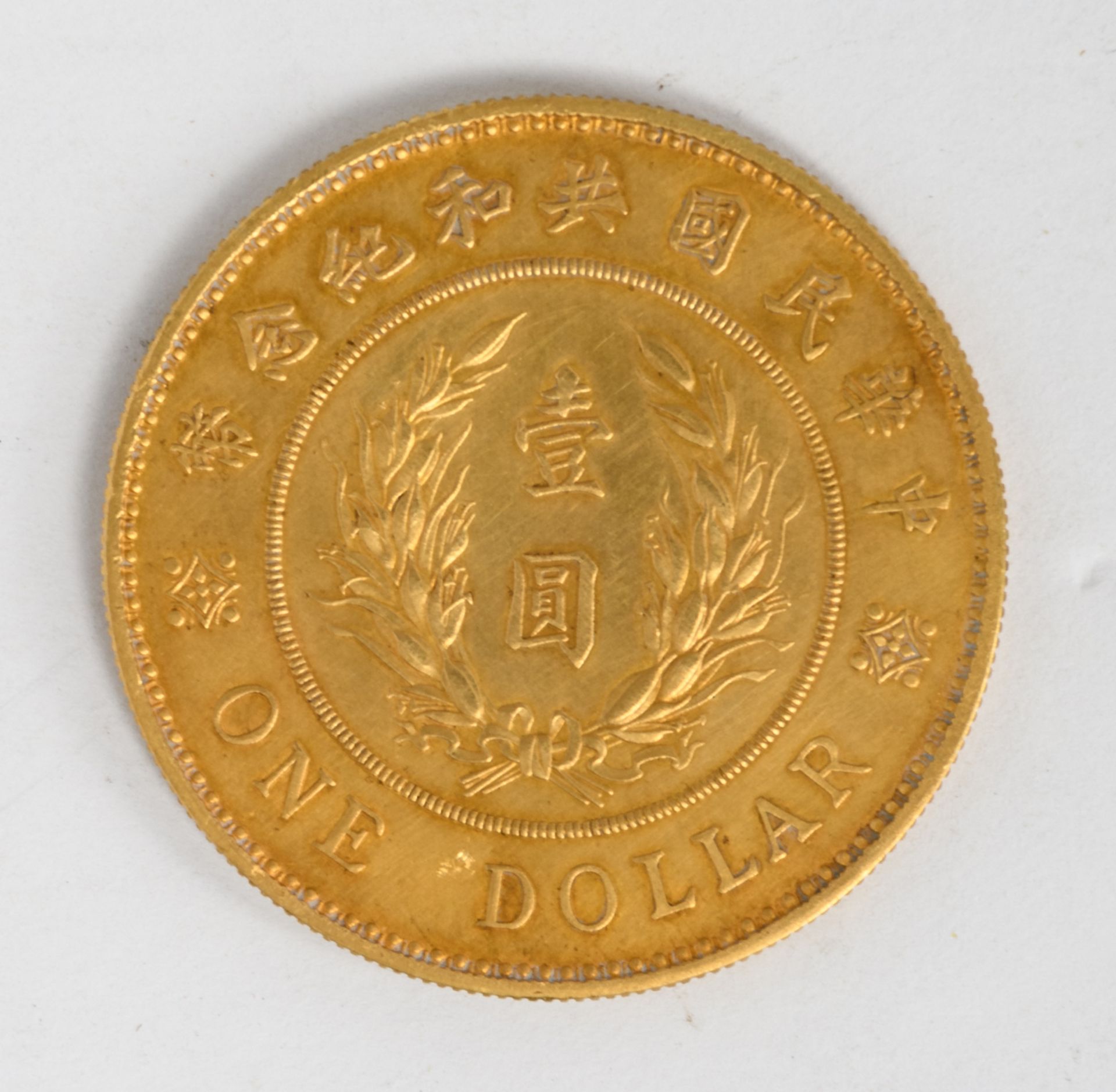 A Chinese commemorative 'golden' one dollar coin, depicting YuanShiKai, signed Giorgi - Image 2 of 2