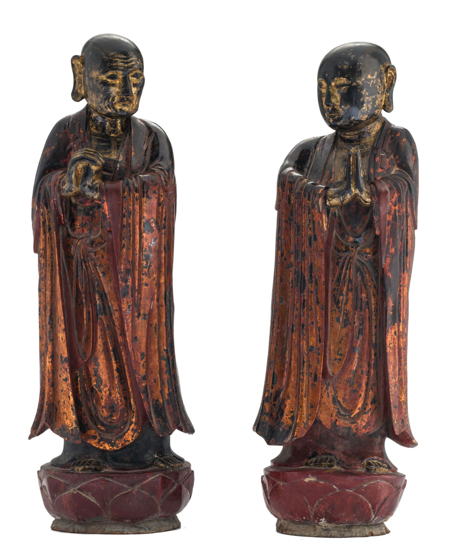 Two Oriental polychrome and gilt lacquered figures, papier maché on wood, depicting Ananda and