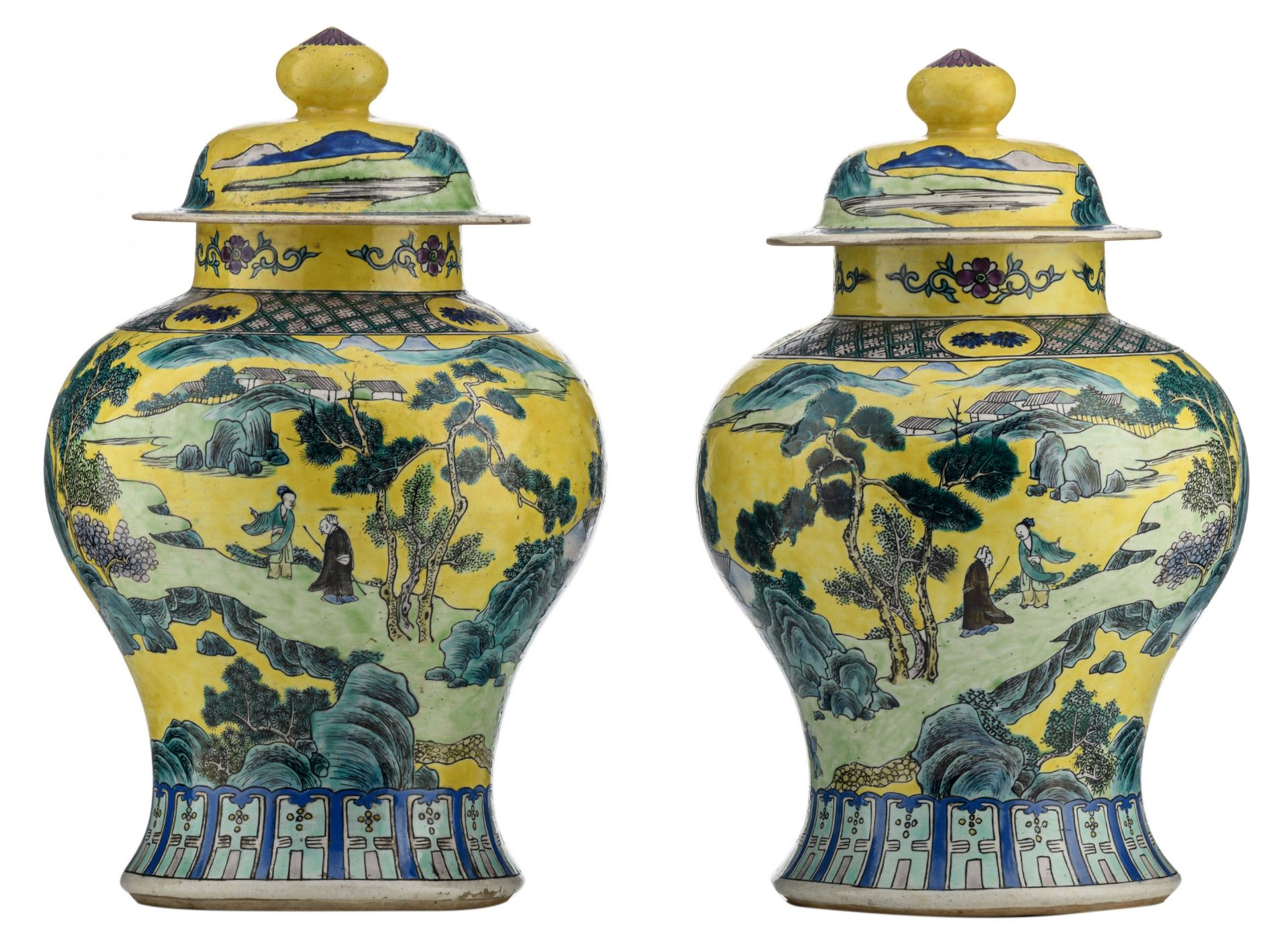 A pair of Chinese yellow ground polychrome vases and covers, overall decorated with figures in a