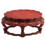 A Chinese red cinnabar lacquered stand with lobed top, the legs ruyi shaped, 18th / 19thC,