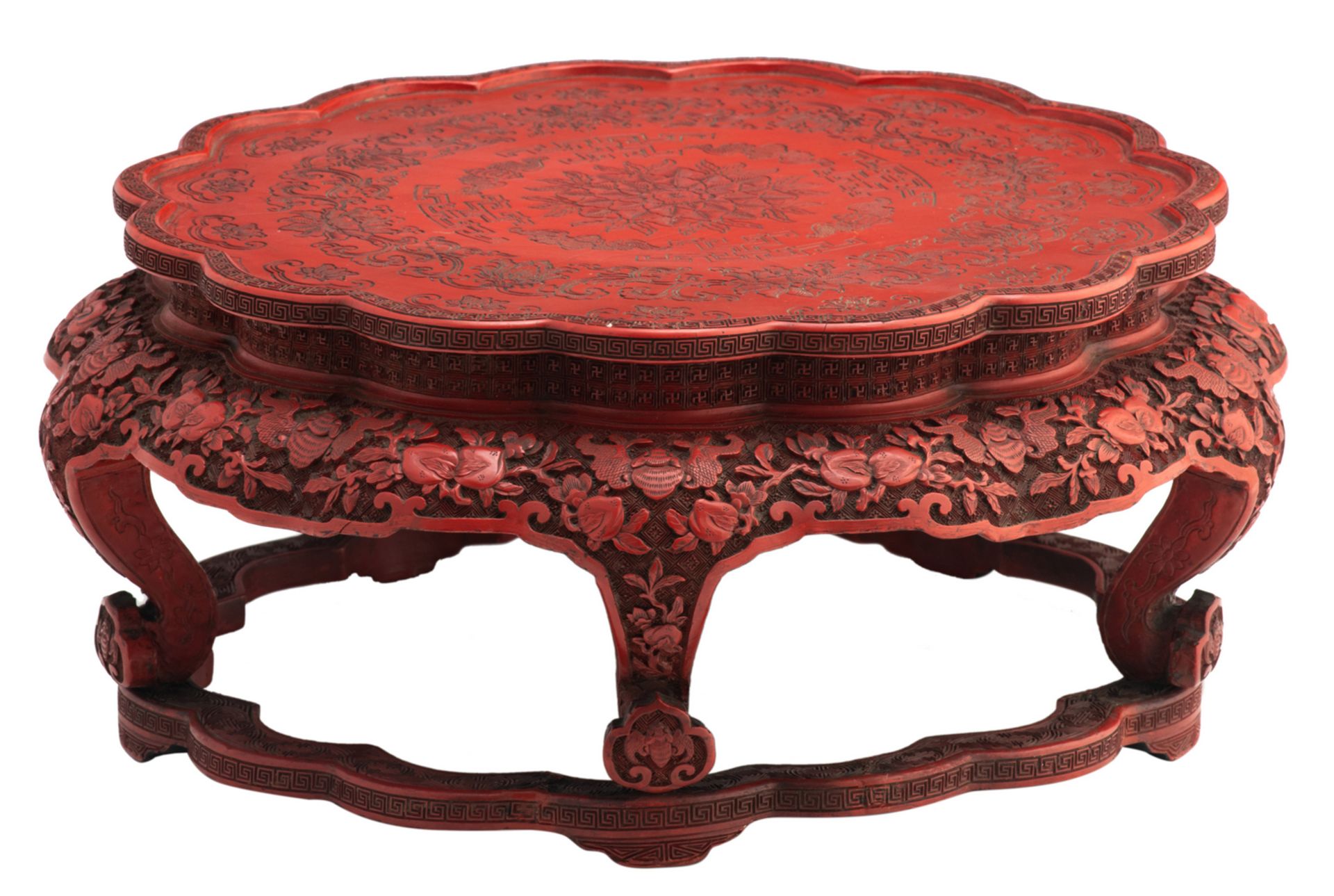 A Chinese red cinnabar lacquered stand with lobed top, the legs ruyi shaped, 18th / 19thC,