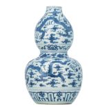 A Chinese blue and white double gourd vase, decorated with dragons and flaming pearls amid clouds, H