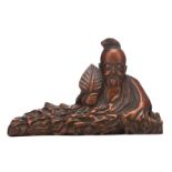 A fine Chinese carved wooden figure, depicting a lying deity, H 11 - W 17 cm