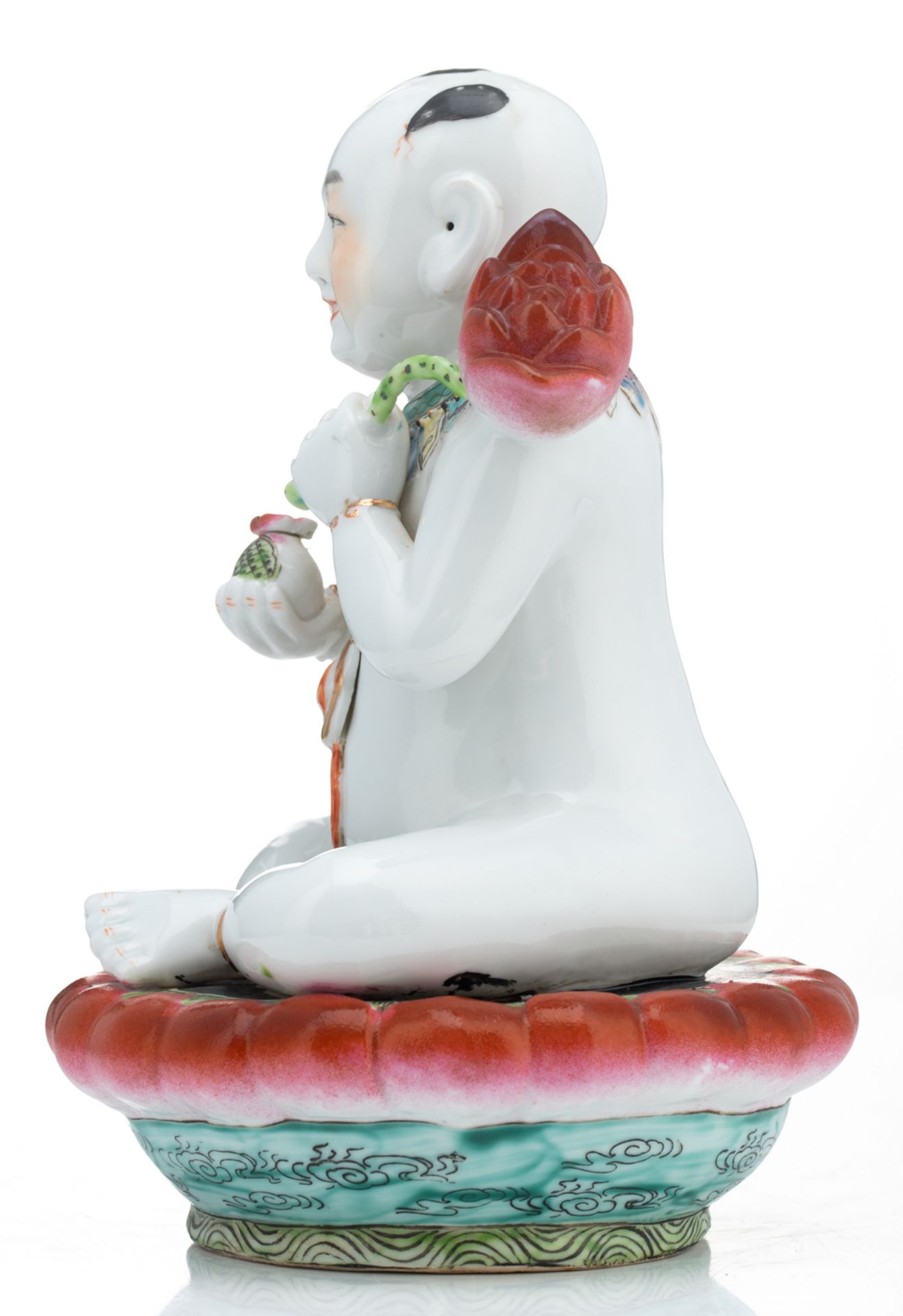 A Chinese famille rose figure of a young Buddha, seated on a lotus base; added a Chinese celadon - Image 9 of 13