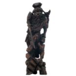 A Chinese carved hardwood group, depicting a warrior-god and a vanquished, H 54,5 cm