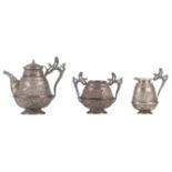 An Indian three-piece silver tea set, no hallmarks found but tested on silver purity, in its
