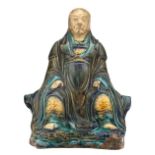 A Chinese polychrome glazed stoneware figure, depicting a seated Buddhistic monk, H 20,5 cm