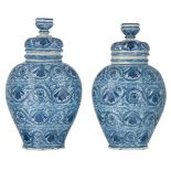 Two blue and white Dutch Delftware jars and covers, decorated with different flowers, marked J.K. (