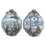 Two tin glazed blue and white plaques, decorated with religious scenes, one dated 1784, mounted with