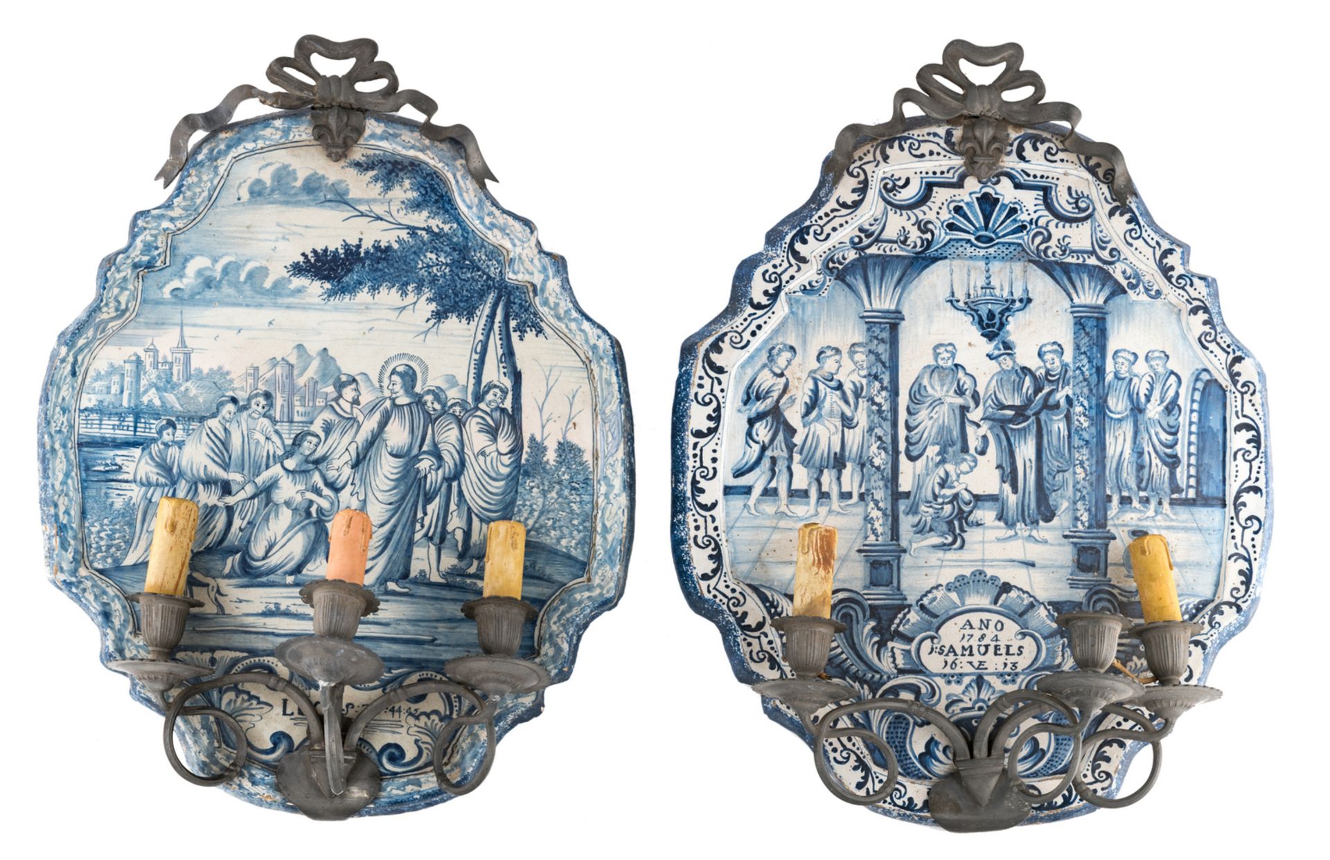 Two tin glazed blue and white plaques, decorated with religious scenes, one dated 1784, mounted with