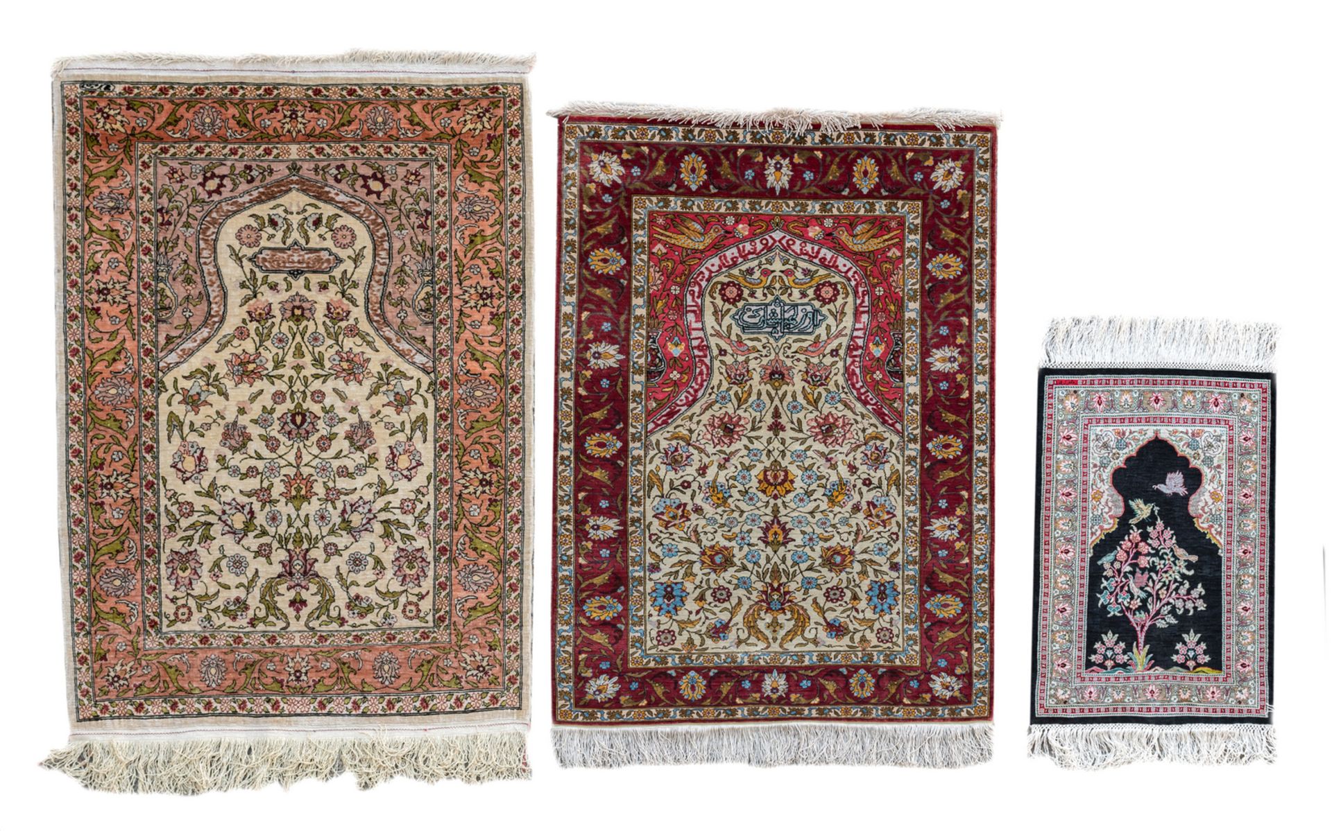 Two Oriental prayer rugs with floral motifs, birds and calligraphic inscriptions, Hereke, silk and