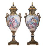 A pair of bleu royal and gilt decorated vases and covers in the Sèvres manner, overall painted