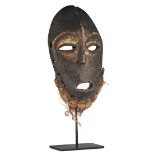 A traditional African wooden mask with fiber, Lega - Congo, H 28 cm