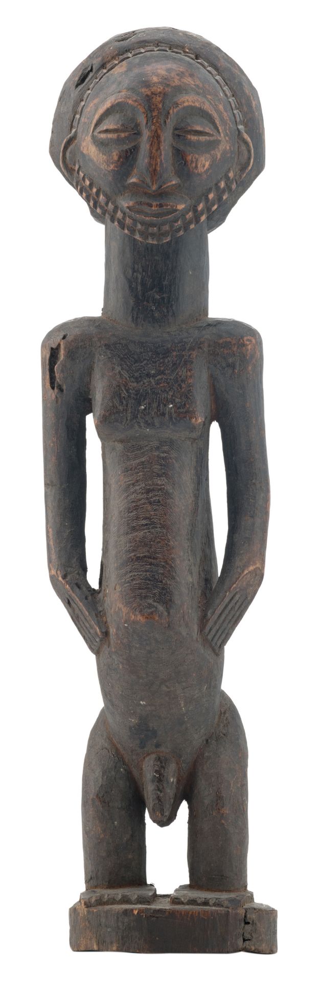 An African wooden sculpture depicting a standing male figure, possibly a chief or an ancestor (