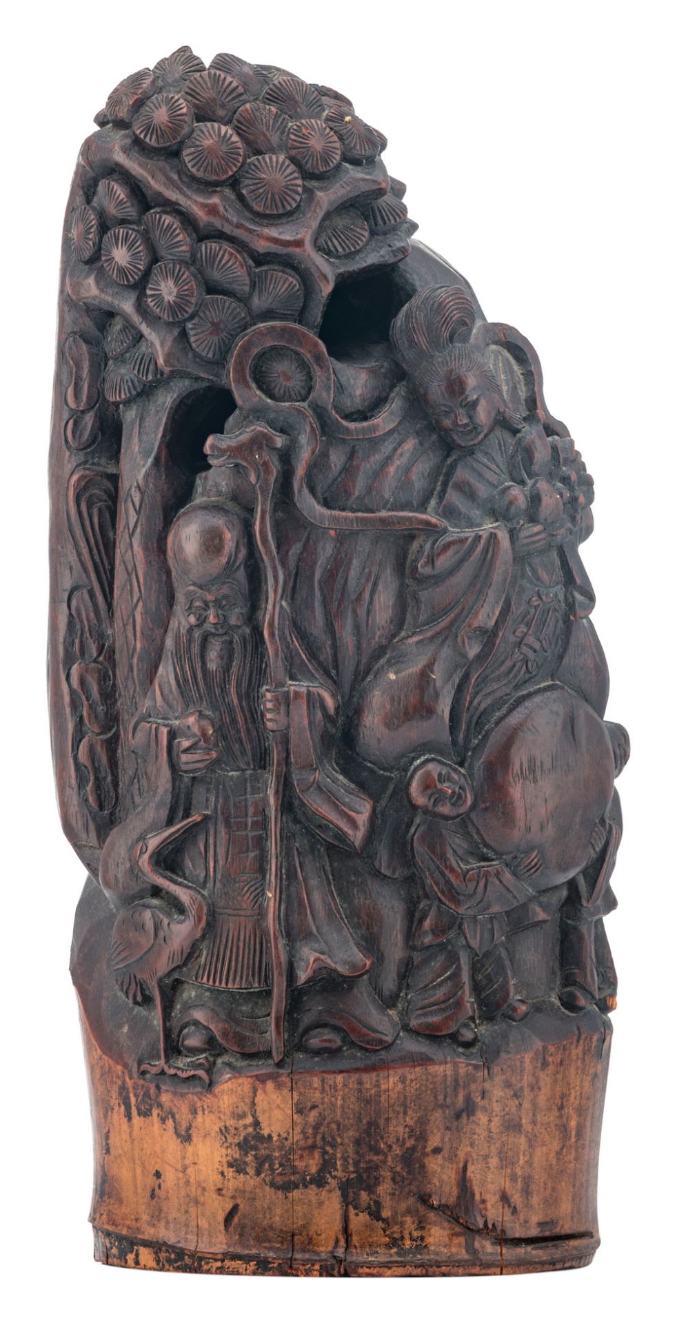 A Chinese bamboo sculpture, depicting the figures of Shou Xing, a Guanyin and some servants, H 40 cm