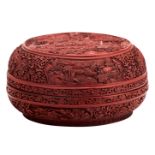 A fine Chinese red cinnabar lacquered bowl and cover, floral decorated, the roundels with