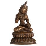 A Sino-Tibetan bronze seated Buddha holding a vajra and a skull cup, with traces of polychromy, H