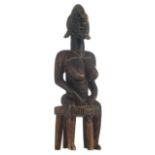 An African wooden sculpture depicting a seated female figure, Bambara - Mali, H 66 cm