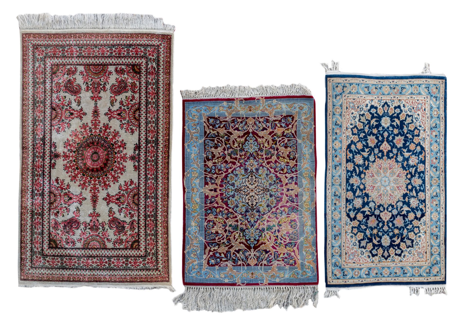 Three Oriental carpets with floral motifs and a central medallion, wool and silk on cotton, Ghom and