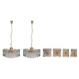 Two gilt brass design chandeliers with cast glass pendants, with accompanying wall lights,