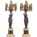 A pair of French gilt bronze candelabras, the female shaped caryatids and the base frieze silver