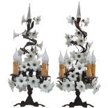 A pair of bronze candelabras mounted with milk glass flowers and set on top with a crystal