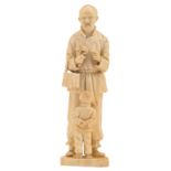 A Japanese Meiji period ivory okimono depicting a lingzhi seller and his son, H 23,5 cm