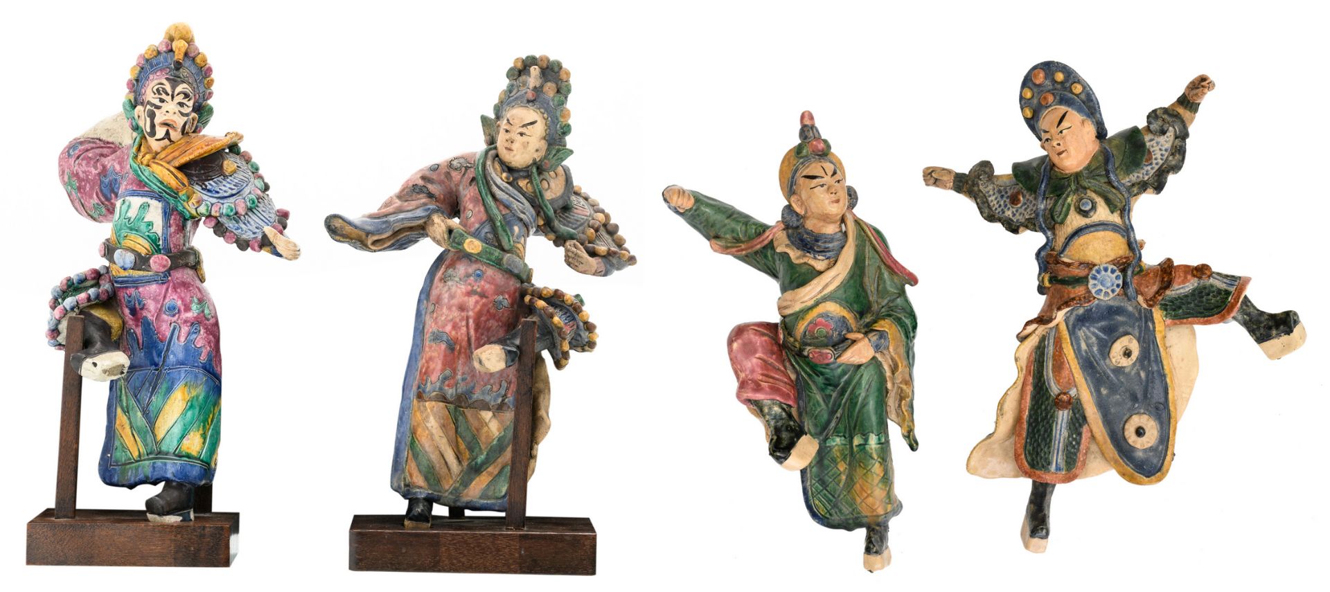 Four Chinese polychrome glazed stoneware figures, two of the figures on a matching wooden stand, H