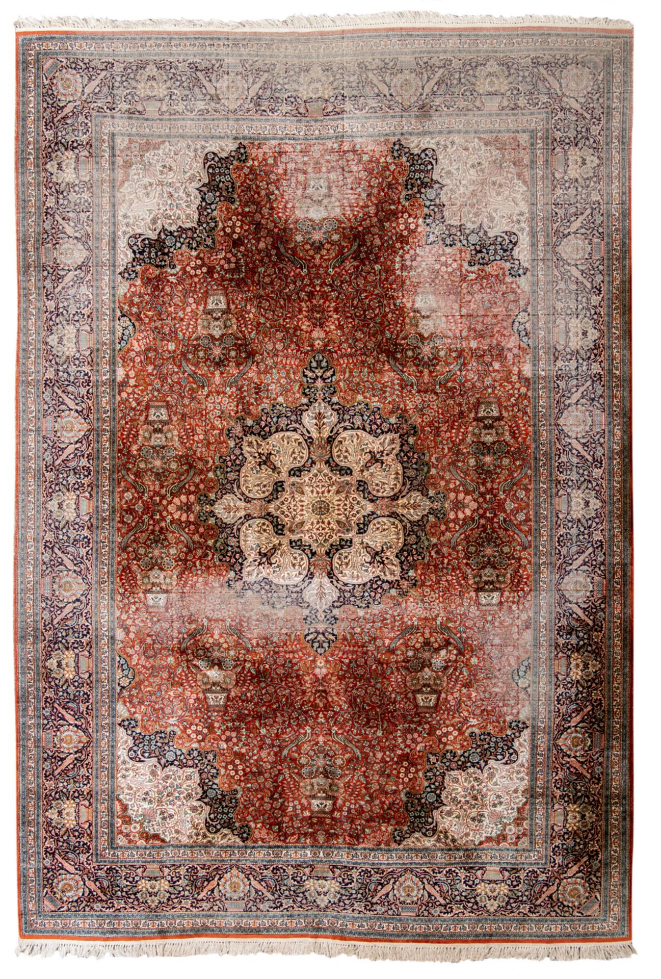 A large and royal Oriental floral decorated silk rug with birds and flower baskets, with a central