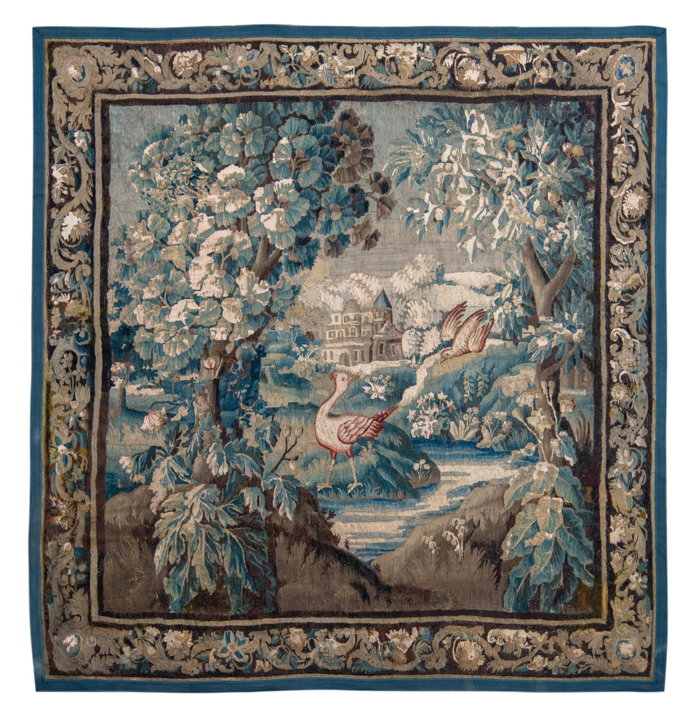 An early 17thC probably Flemish tapestry depicting birds in front of a castle in an imaginary forest