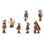 Seven Goebel and Hummel boy and girl figurines, one of which a special edition of 'Het Volk', 1948-