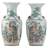 A pair of Chinese polychrome vases, decorated with ladies and children in a garden, and calligraphic