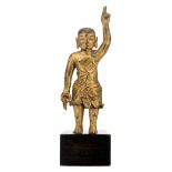 A Chinese standing gilt bronze figure of an infant Buddha, mounted on a wooden base, H 16,5 (without