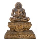 A Thai gilt and polychrome lacquered bronze seated Buddha on a multi-stepped base, with glass inlay,