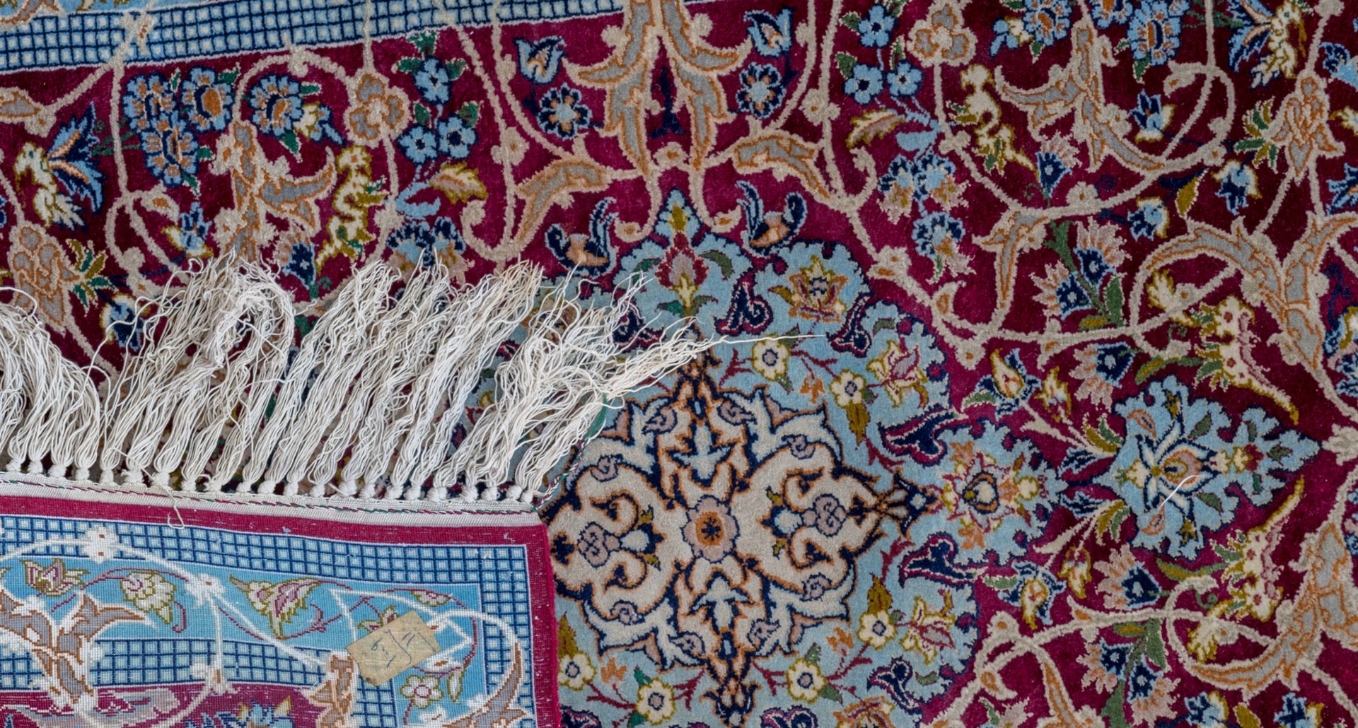 Three Oriental carpets with floral motifs and a central medallion, wool and silk on cotton, Ghom and - Image 4 of 5