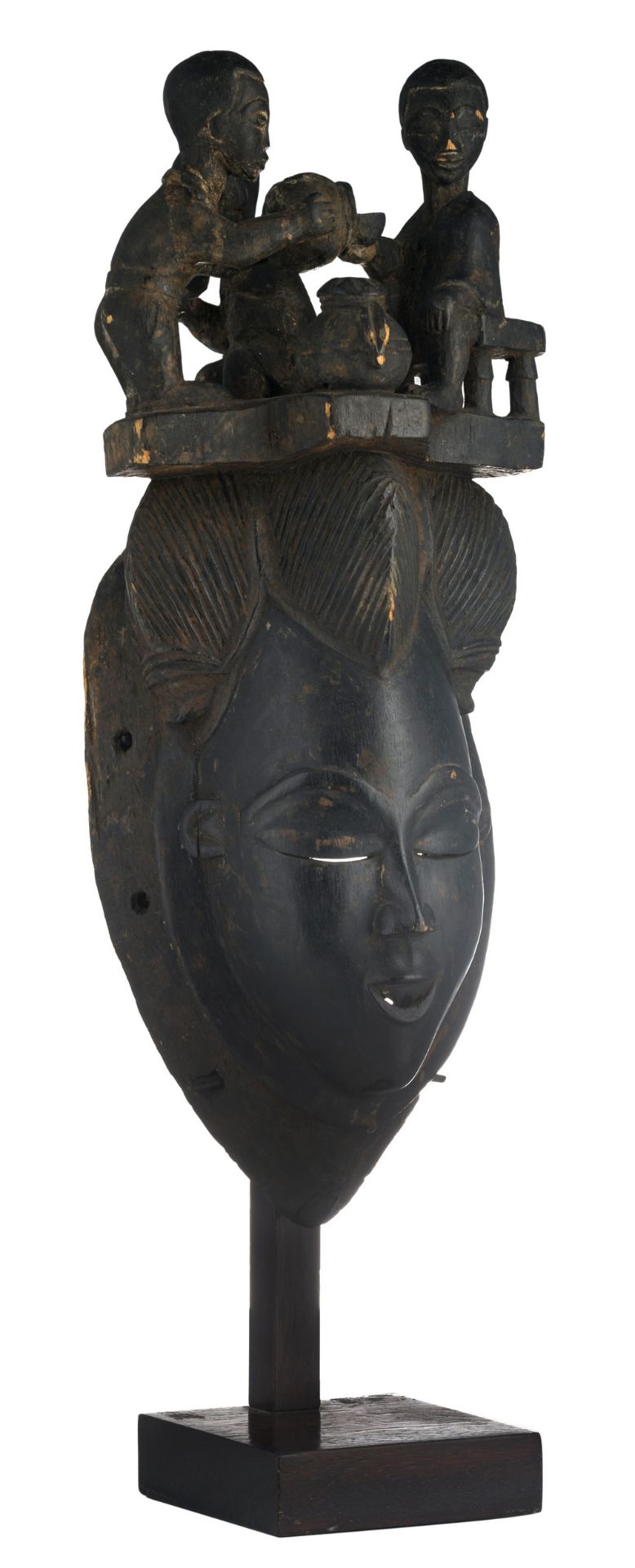 A traditional African wooden mask crowned with an animated scene, Yaouré - Ivory Coast, H 42,5 cm