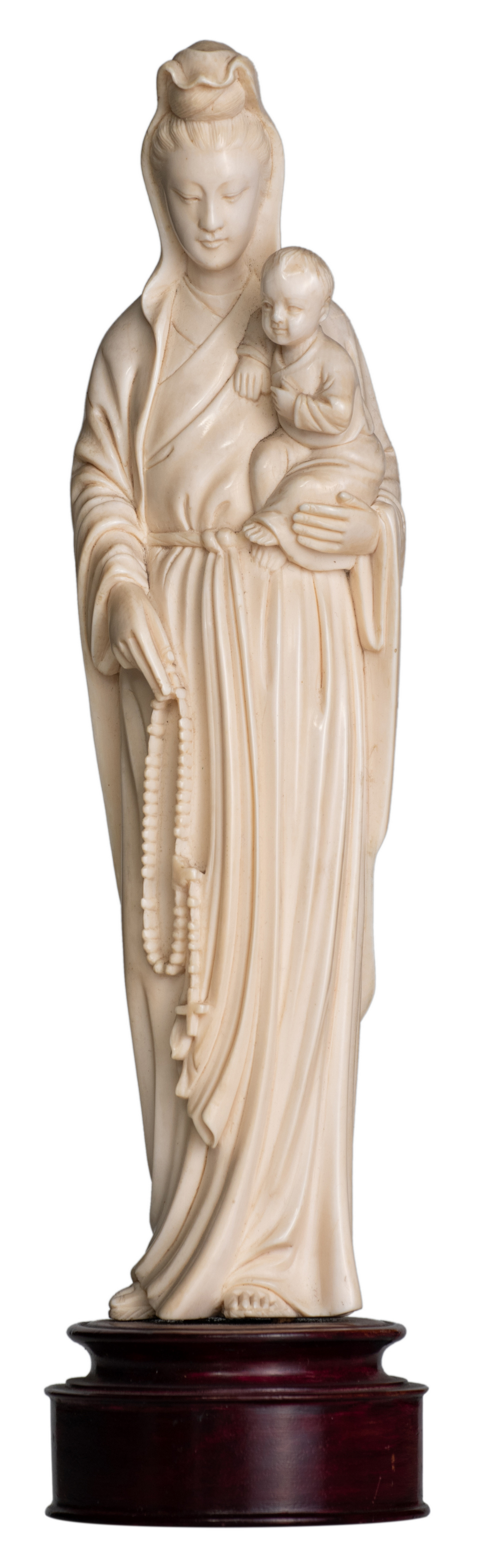 A Chinese ivory sculpture depicting the Virgin and Child, first half of the 20thC, on a wooden base,